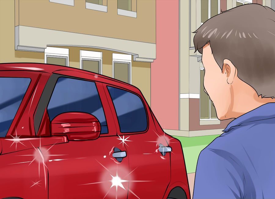 A man looking at his freshly washed, sparkling red car